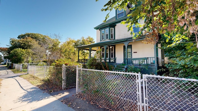 143 Union Ave, Old Orchard Beach, ME 04064 - view of front facade with a gate, a porch, a fenced front yard, and stairs