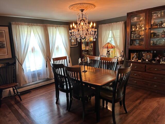 48 Allen St, Bangor, ME 04401 - dining area featuring a chandelier and dark wood-style flooring