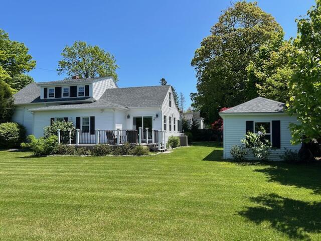 48 Allen St, Bangor, ME 04401 - rear view of house with a lawn and roof with shingles