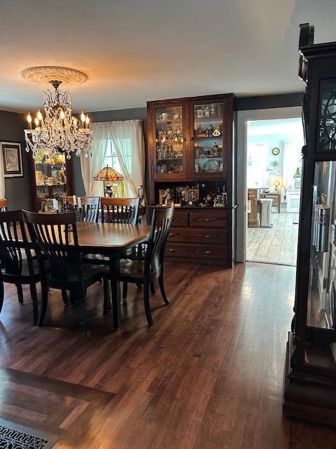 48 Allen St, Bangor, ME 04401 - dining area with dark wood-style floors and a chandelier