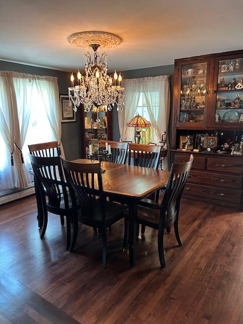 48 Allen St, Bangor, ME 04401 - dining area with dark wood-style flooring and a chandelier
