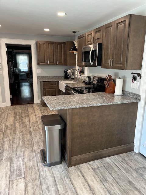 48 Allen St, Bangor, ME 04401 - kitchen featuring stainless steel microwave, electric range oven, light wood-style floors, a peninsula, and recessed lighting