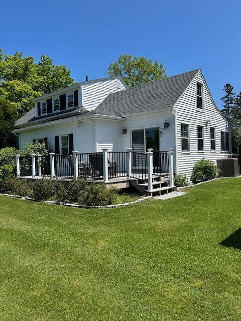 48 Allen St, Bangor, ME 04401 - back of house featuring central AC unit, a deck, a lawn, and a shingled roof