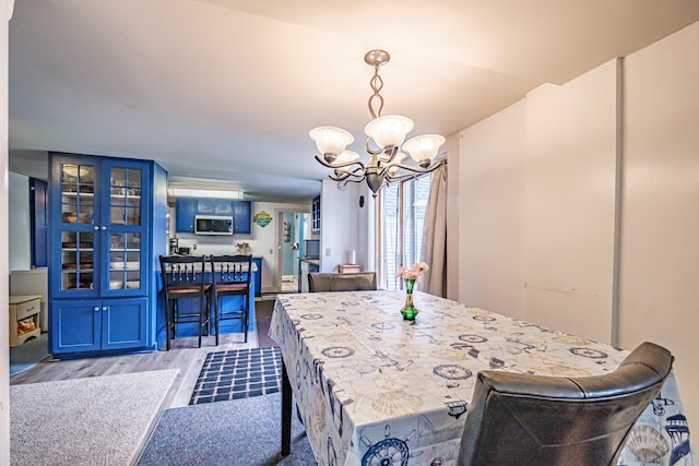 11 Stuart St, Saco, ME 04072 - dining space featuring wood finished floors and a chandelier