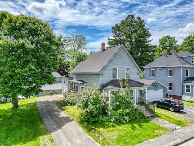 4 Heath St, Waterville, ME 04901 - view of front of home featuring a front lawn, driveway, a garage, and a chimney