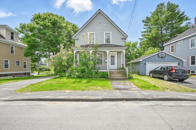 4 Heath St, Waterville, ME 04901 - view of front of home featuring a porch, an outbuilding, a front yard, and a detached garage