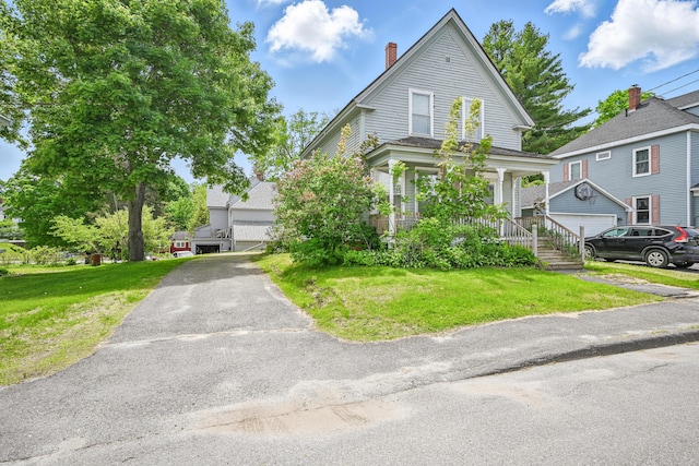 4 Heath St, Waterville, ME 04901 - view of front of house with a front yard, a chimney, covered porch, and a garage