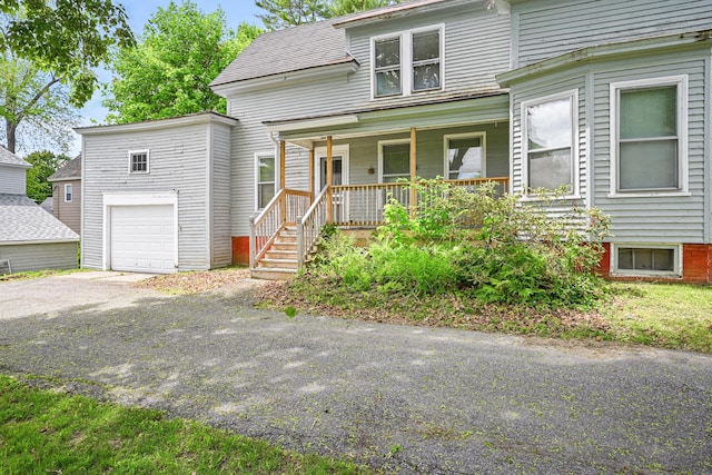 4 Heath St, Waterville, ME 04901 - view of front facade with covered porch, driveway, and an attached garage