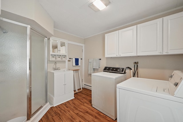 4 Heath St, Waterville, ME 04901 - laundry room featuring washing machine and clothes dryer, wood finished floors, baseboard heating, crown molding, and cabinet space