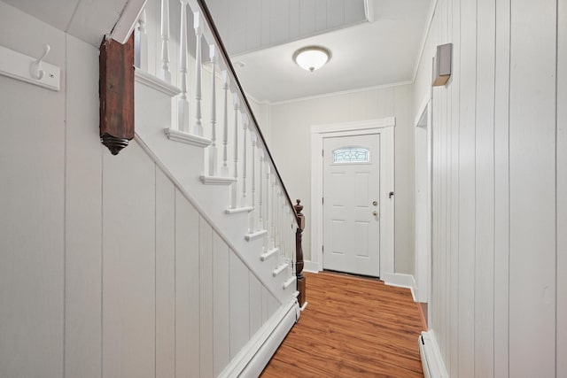 4 Heath St, Waterville, ME 04901 - doorway to outside featuring wood finished floors, stairs, crown molding, baseboards, and wood walls