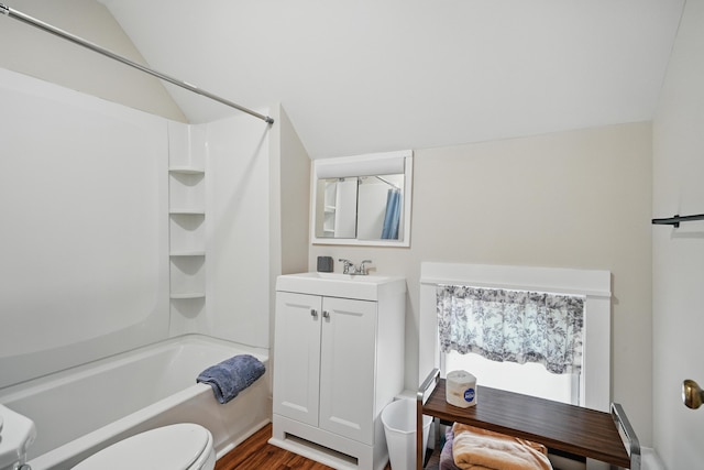 4 Heath St, Waterville, ME 04901 - bathroom featuring vanity, bathing tub / shower combination, toilet, vaulted ceiling, and wood finished floors