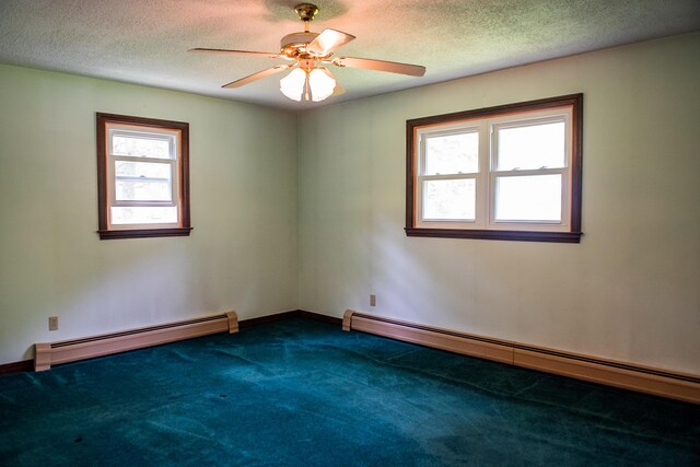 130 Davis Rd, Fairfield, ME 04937 - spare room with a baseboard radiator, healthy amount of natural light, dark colored carpet, and a textured ceiling