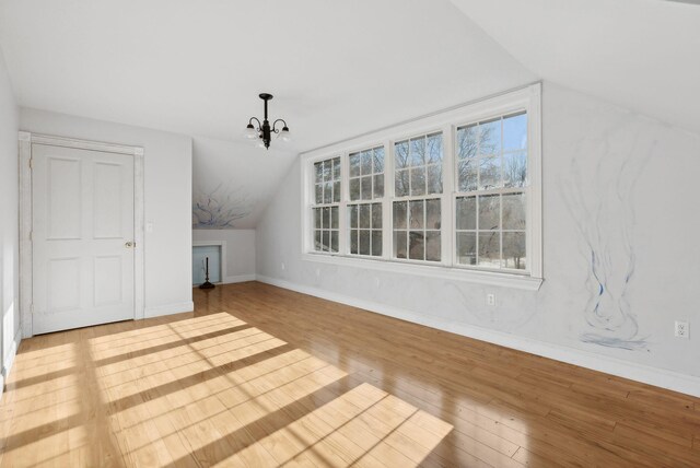 454 N Parish Rd, Turner, ME 04282 - additional living space with lofted ceiling, hardwood / wood-style flooring, baseboards, and a chandelier
