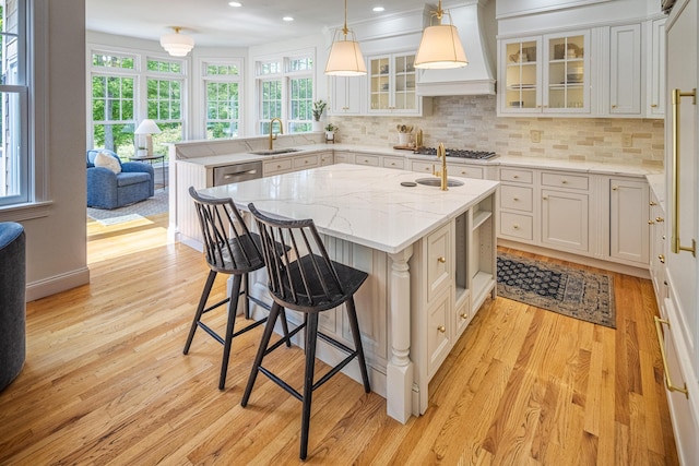 20 Doe Dr, Eliot, ME 03903 - kitchen featuring light wood-style floors, a kitchen island with sink, decorative backsplash, custom exhaust hood, and recessed lighting