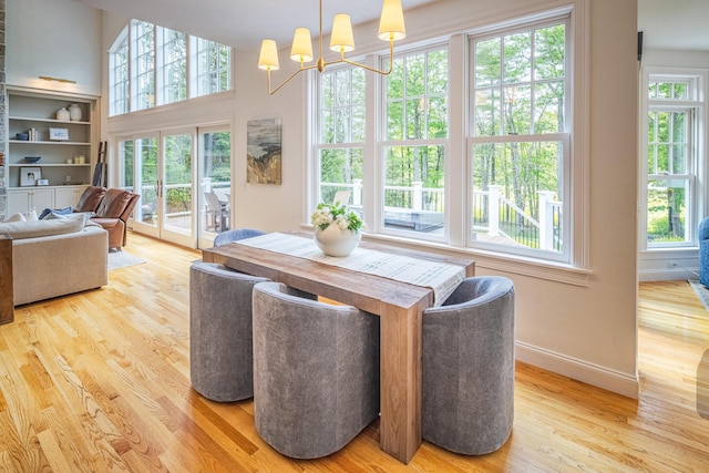 20 Doe Dr, Eliot, ME 03903 - dining space featuring healthy amount of natural light, wood finished floors, baseboards, and a chandelier