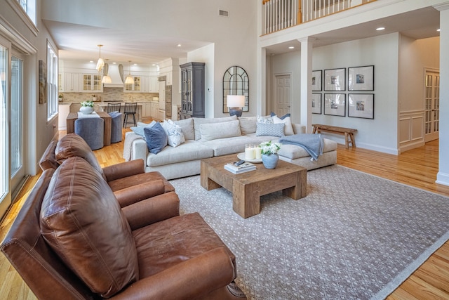 20 Doe Dr, Eliot, ME 03903 - living room with light wood finished floors, plenty of natural light, recessed lighting, a towering ceiling, and decorative columns
