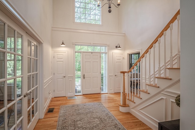 20 Doe Dr, Eliot, ME 03903 - foyer featuring a high ceiling, wood finished floors, plenty of natural light, and stairs