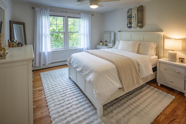 20 Doe Dr, Eliot, ME 03903 - bedroom featuring baseboard heating, light wood-style floors, and a ceiling fan