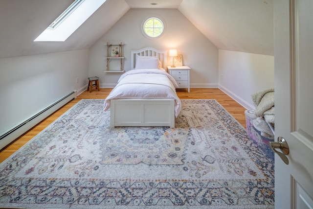 20 Doe Dr, Eliot, ME 03903 - bedroom with a skylight, a baseboard radiator, vaulted ceiling, light wood-type flooring, and baseboards
