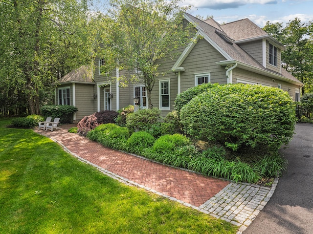20 Doe Dr, Eliot, ME 03903 - view of front of house with a shingled roof, a front lawn, and a garage