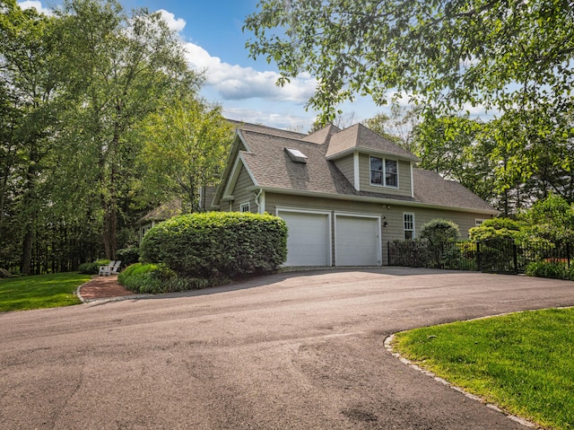 20 Doe Dr, Eliot, ME 03903 - view of front of house featuring asphalt driveway, roof with shingles, and a garage