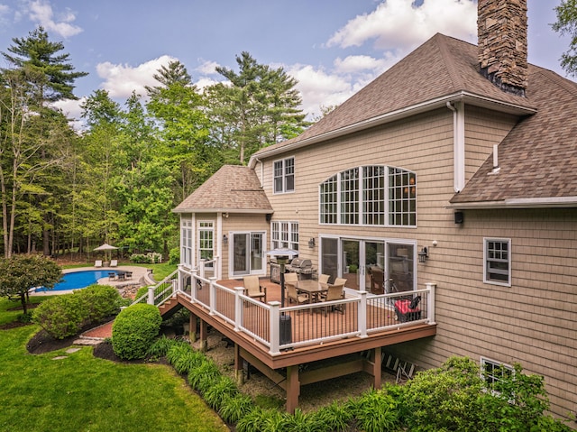 20 Doe Dr, Eliot, ME 03903 - rear view of property featuring a shingled roof, an outdoor pool, a wooden deck, and a chimney