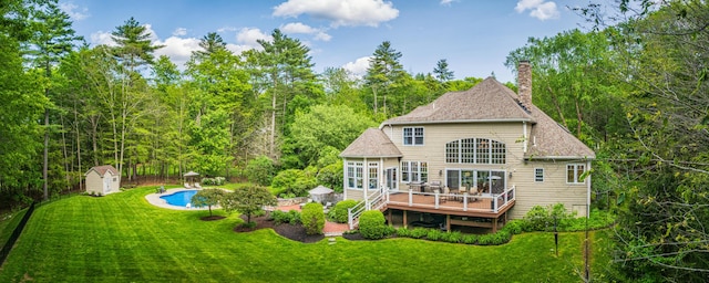 20 Doe Dr, Eliot, ME 03903 - back of house featuring a deck, a yard, an outdoor pool, a chimney, and a shingled roof
