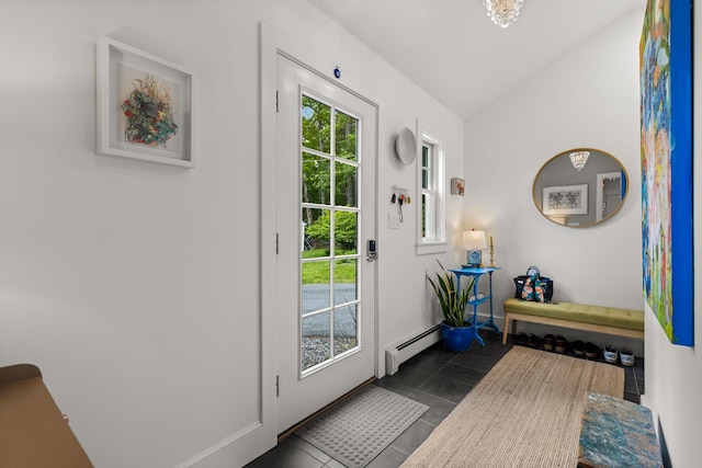 83 Brixham Rd, York, ME 03909 - doorway to outside with a baseboard heating unit, vaulted ceiling, dark tile patterned flooring, and baseboards
