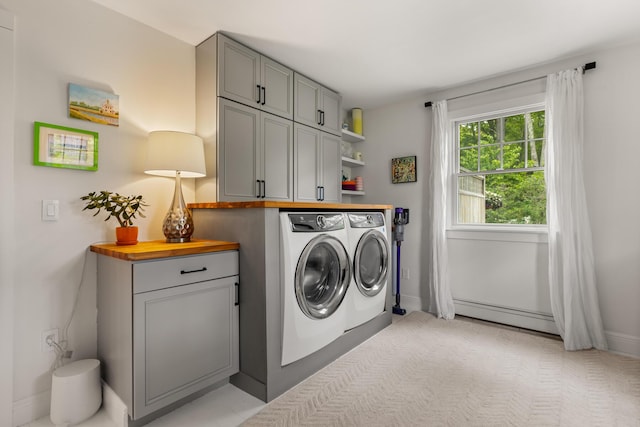 83 Brixham Rd, York, ME 03909 - laundry area featuring washing machine and clothes dryer, cabinet space, a baseboard radiator, and baseboards