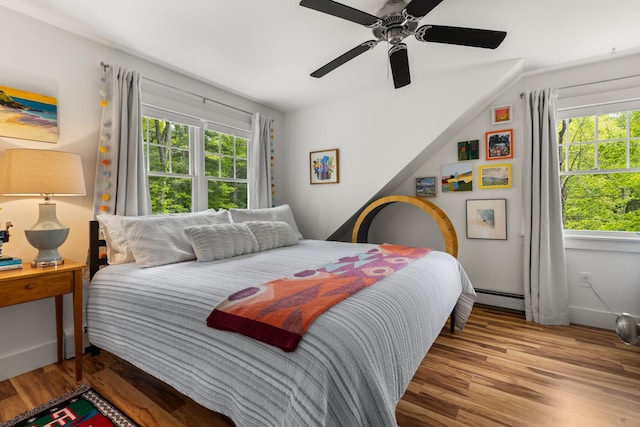 83 Brixham Rd, York, ME 03909 - bedroom with multiple windows, a baseboard radiator, wood finished floors, and ceiling fan