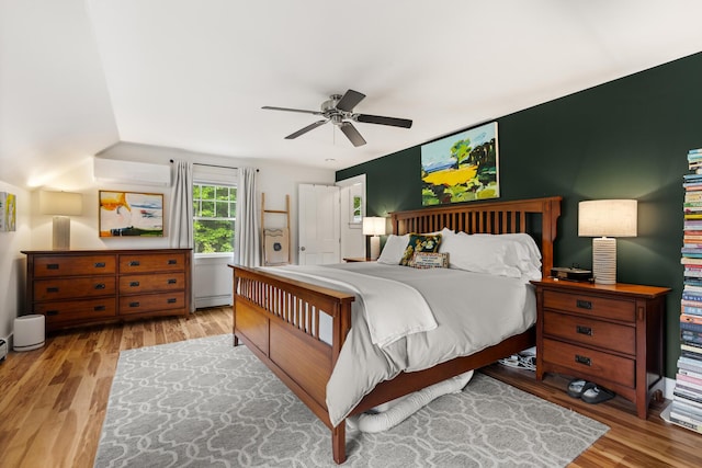 83 Brixham Rd, York, ME 03909 - bedroom featuring a baseboard radiator, wood finished floors, an AC wall unit, and ceiling fan