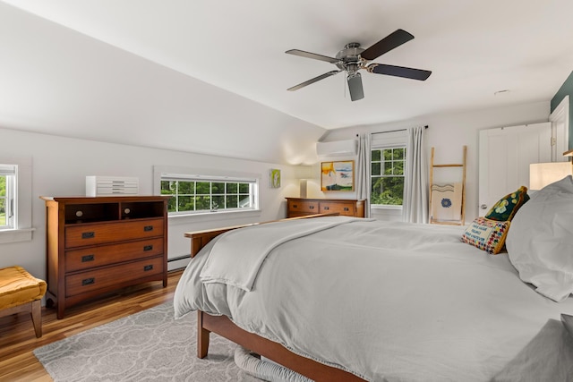 83 Brixham Rd, York, ME 03909 - bedroom with a wall mounted AC, multiple windows, light wood-style flooring, a ceiling fan, and lofted ceiling