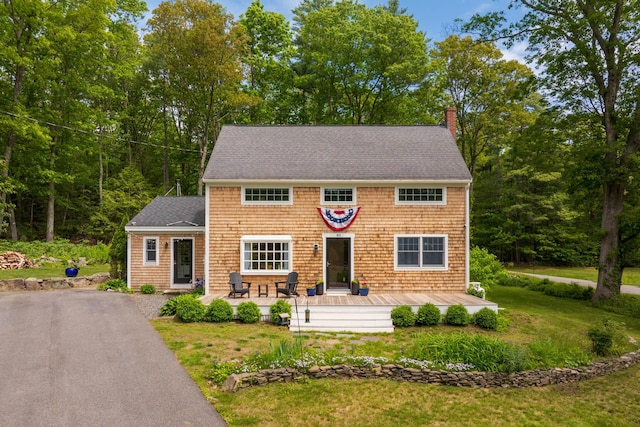 83 Brixham Rd, York, ME 03909 - view of front of house featuring a chimney, a front yard, a shingled roof, and asphalt driveway