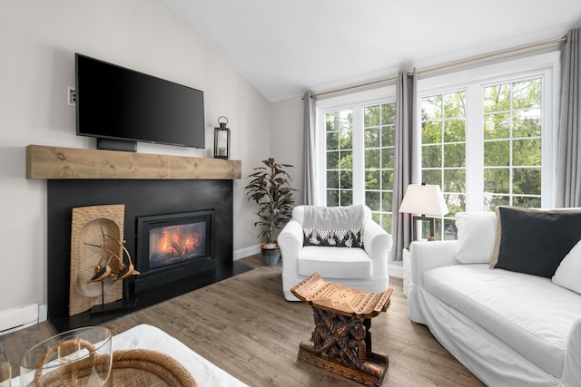 36 Bayberry Ave, Kennebunk, ME 04043 - living room featuring vaulted ceiling, a fireplace with flush hearth, wood finished floors, and baseboards