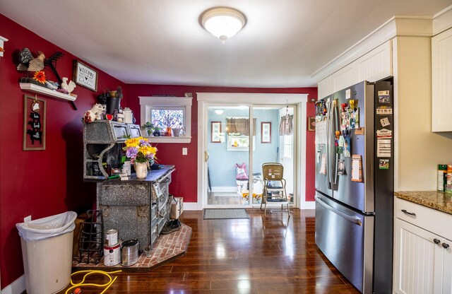 590 Main St, East Machias, ME 04630 - bar with stainless steel fridge, dark wood-style flooring, baseboards, and plenty of natural light
