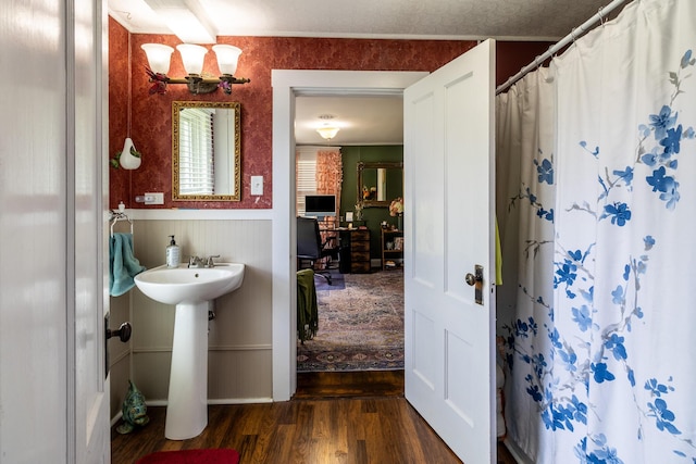 590 Main St, East Machias, ME 04630 - full bath with wood finished floors, a wainscoted wall, a shower with shower curtain, and a sink