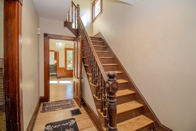 12 Park Ave, Newport, ME 04953 - staircase with wood finished floors and a chandelier