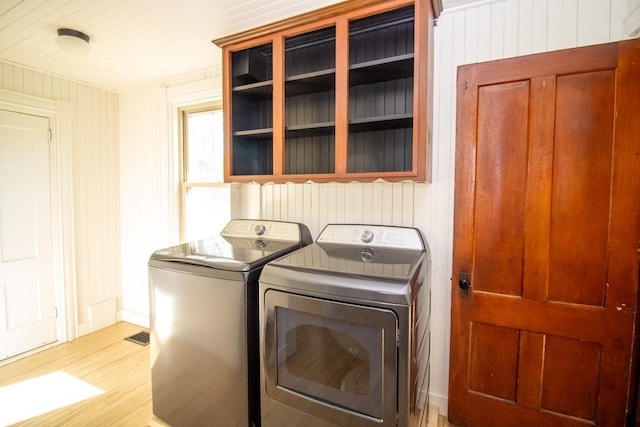 12 Park Ave, Newport, ME 04953 - laundry area featuring separate washer and dryer, light wood finished floors, and wooden walls