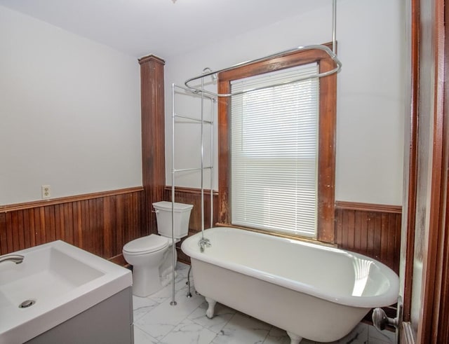 12 Park Ave, Newport, ME 04953 - full bath with a wainscoted wall, wooden walls, a freestanding bath, marble finish floors, and vanity