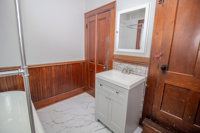 12 Park Ave, Newport, ME 04953 - bathroom with vanity, marble finish flooring, wainscoting, wooden walls, and a tub
