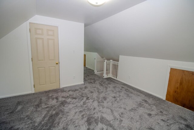 12 Park Ave, Newport, ME 04953 - additional living space featuring vaulted ceiling, carpet floors, and baseboards