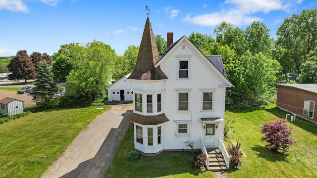 123 Main St, Newport, ME 04953 - rear view of house with a chimney, a yard, and driveway