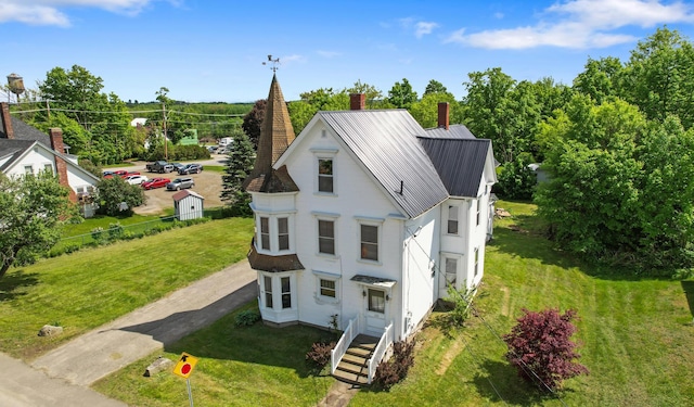 123 Main St, Newport, ME 04953 - view of front of home featuring a chimney, a front yard, and metal roof