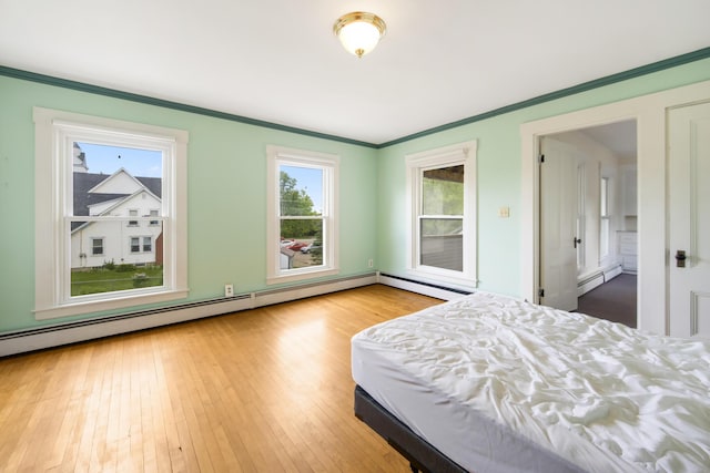 123 Main St, Newport, ME 04953 - bedroom with a baseboard heating unit, ornamental molding, and wood-type flooring