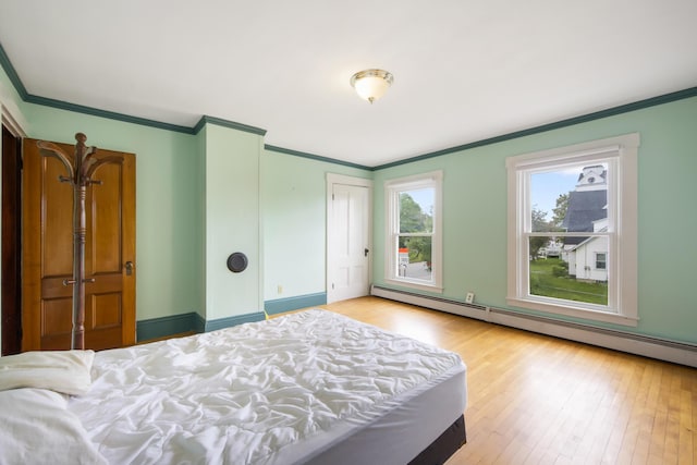 123 Main St, Newport, ME 04953 - bedroom with crown molding, a baseboard heating unit, and wood finished floors