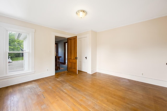 123 Main St, Newport, ME 04953 - empty room with light wood-style floors, baseboards, and ornamental molding