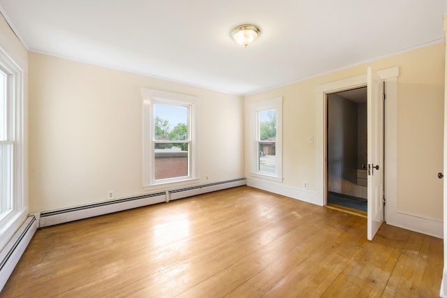 123 Main St, Newport, ME 04953 - empty room with a baseboard heating unit and light wood-style flooring
