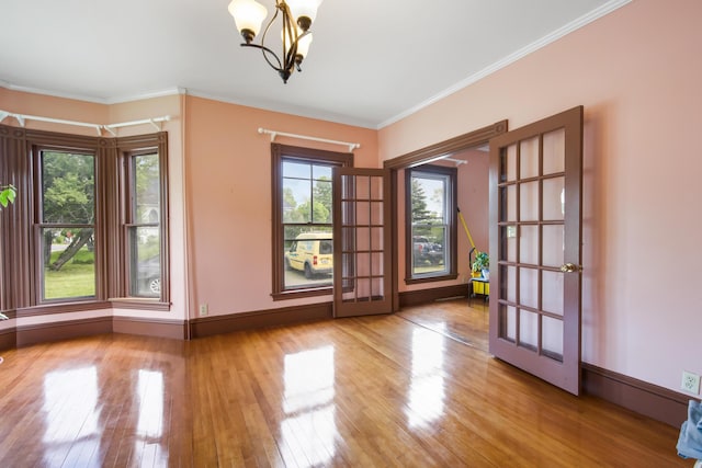 123 Main St, Newport, ME 04953 - empty room with a chandelier, wood finished floors, and ornamental molding