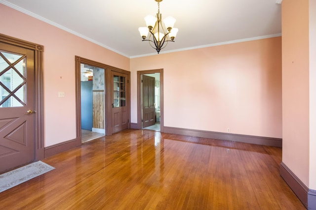 123 Main St, Newport, ME 04953 - unfurnished room with a chandelier, wood finished floors, baseboards, and ornamental molding