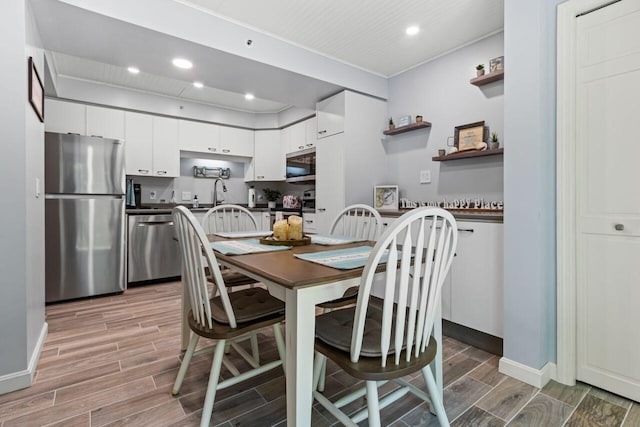 131 Temple Ave Unit 26, Old Orchard Beach, ME 04064 - dining area with wood finish floors, recessed lighting, baseboards, and ornamental molding